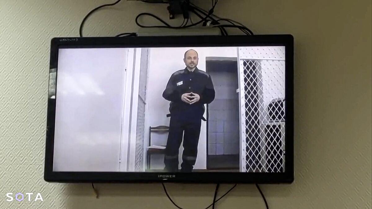 Russian opposition activist Vladimir Kara-Murza is seen on a TV screen.