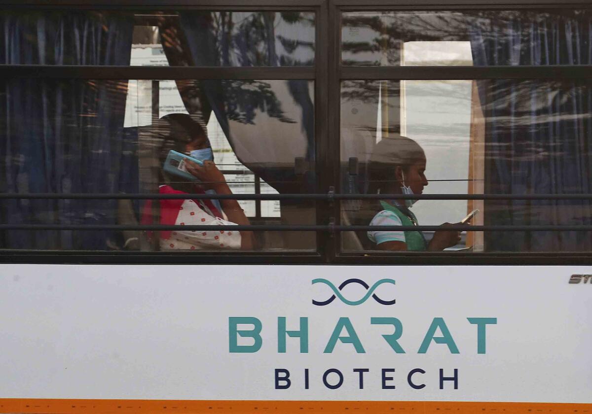 FILE- An employee of Bharat Biotech speaks on a mobile phone inside a bus on the outskirts of Hyderabad, India, Saturday, Jan. 9, 2021. India on Tuesday, Sept. 6, 2022, cleared a new approach to COVID-19 vaccination, a nasal version designed to fight the virus right where it enters the body. The vaccine was developed by scientists at Washington University in St. Louis and later licensed to Indian vaccine maker Bharat Biotech. (AP Photo/Mahesh Kumar A., File)