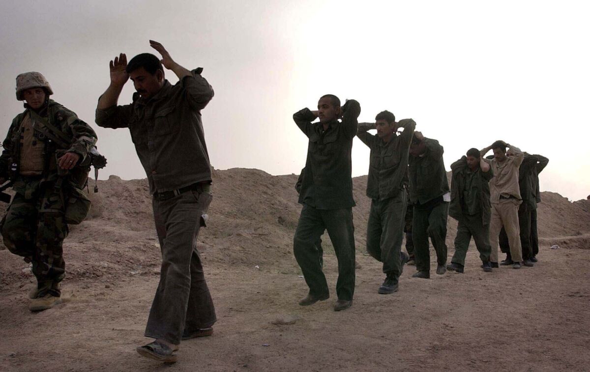 Iraqi soldiers surrender to US Marines in this March 21, 2003 file photo. 