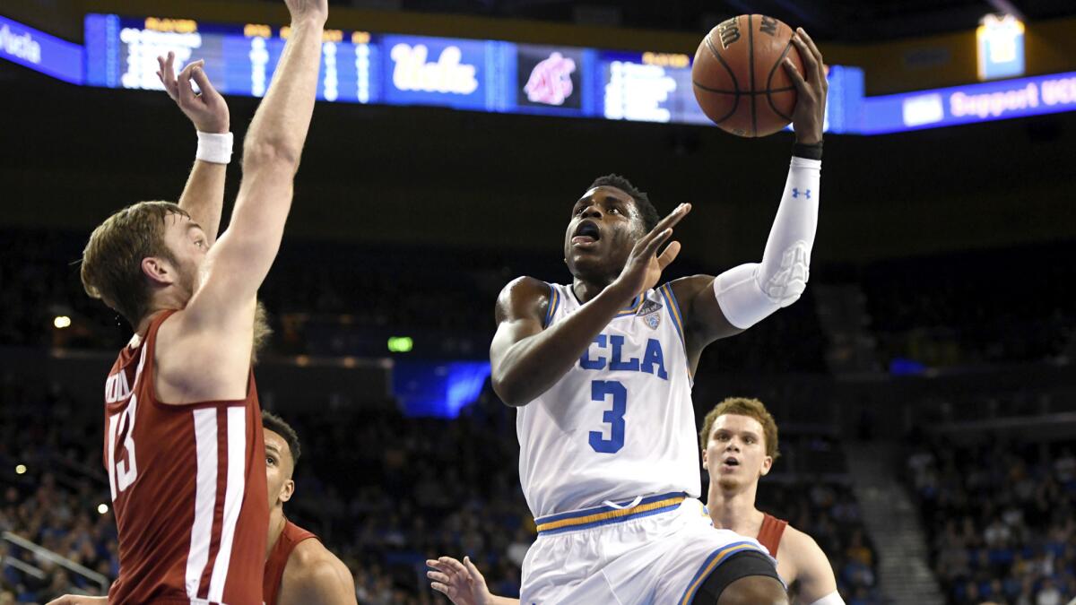 UCLA guardAaron Holiday drives to the basket for a layup against Washington State during the first half Friday night.