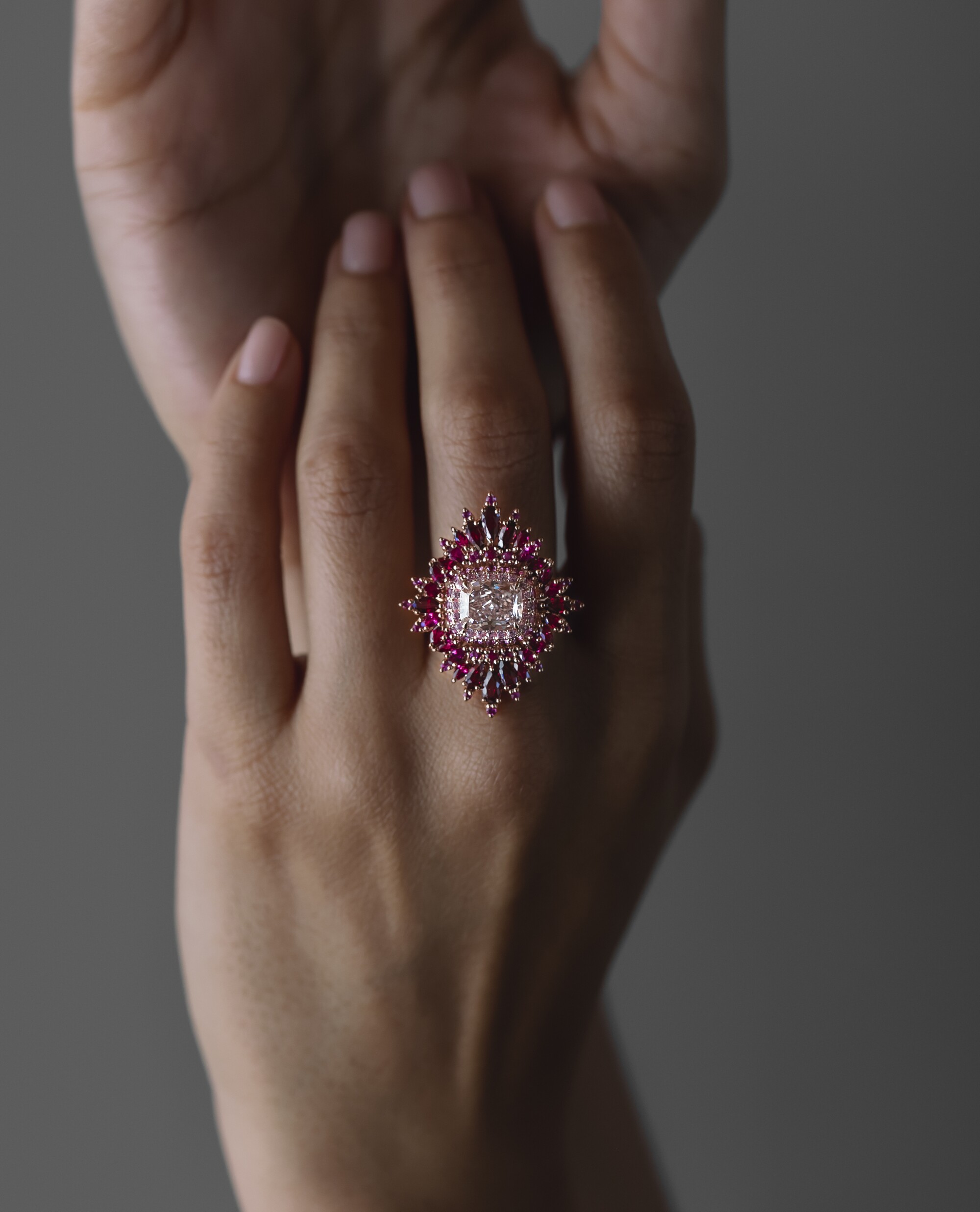 Close up of hand wearing large intricate ring designed by Maggi Simpkins.