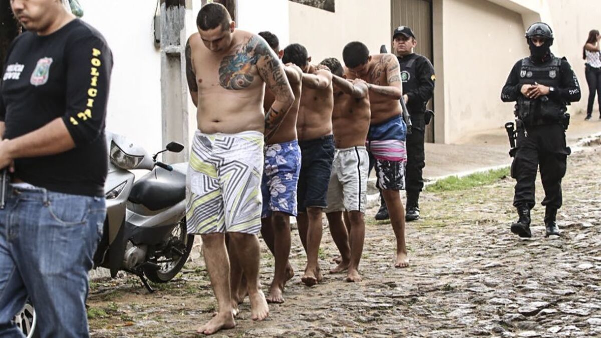 Police guard several inmates in a jail in Itapaje, Brazil, on Jan. 29, 2018.