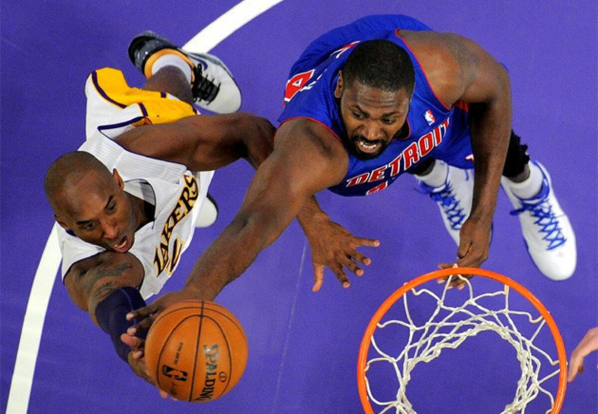 Kobe Bryant drives to the basket as Detroit's Jason Maxiell defends during a game earlier this season.