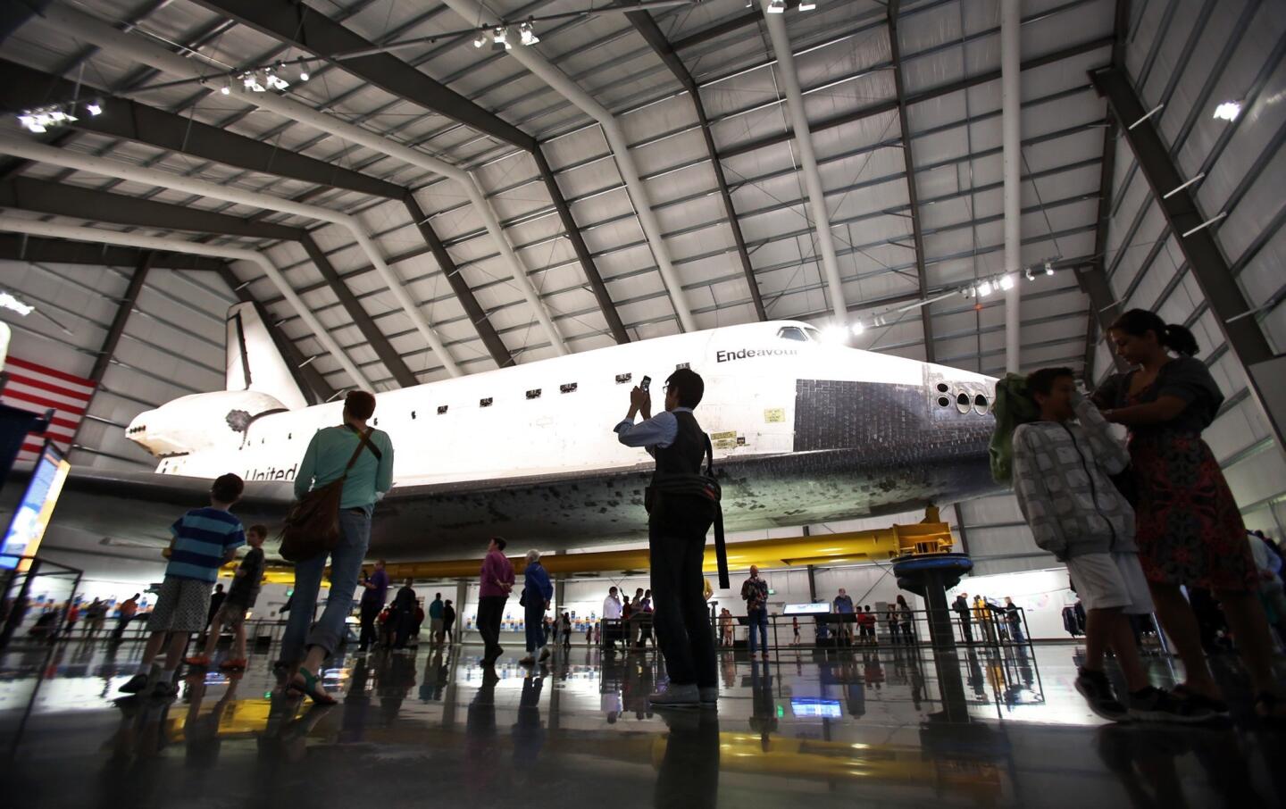 Visitors view the space shuttle Endeavour at the California Science Center. More than 1 million people have visited since Endeavour made its debut just over four months ago, far surpassing officials' expectations for the Exposition Park museum.