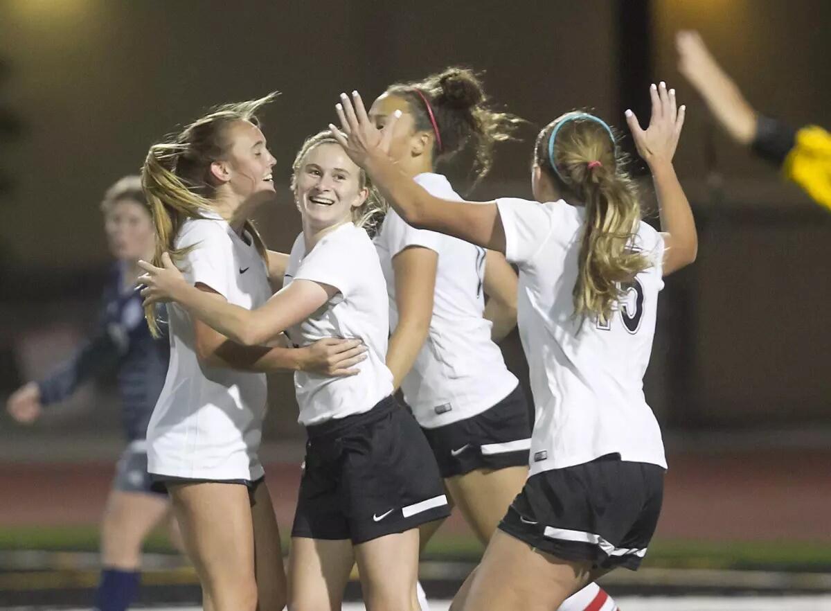 Jenna Nighswonger, center, celebrates with her Huntington Beach girls' soccer teammates after scoring a goal in 2017.