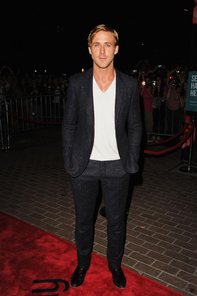 Ryan Gosling wears a dark blue Donegal wool tweed suit by Burberry Prorsum.