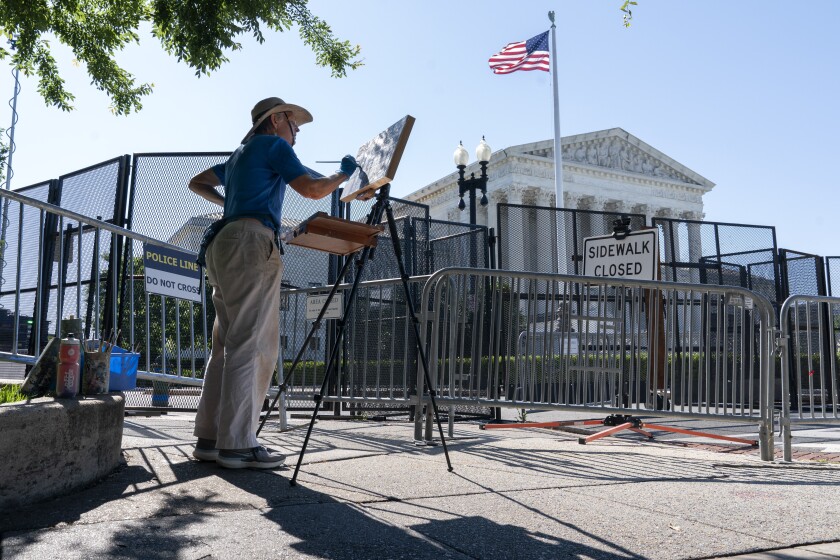 Artist Elaine Wilson works on a painting of the Supreme Court, Wednesday, June 29, 2022, in Washington. (AP Photo/Jacquelyn Martin)