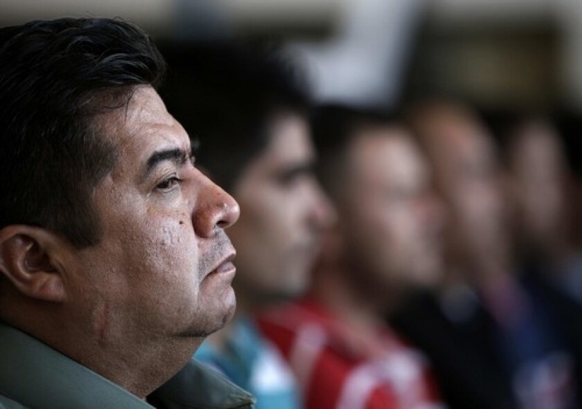 Javier Ortiz, a former Michoacan state police officer, appears at a news conference in Mexico City with nine other people suspected of having ties to a drug cartel. A top advisor to the states governor was among those detained.