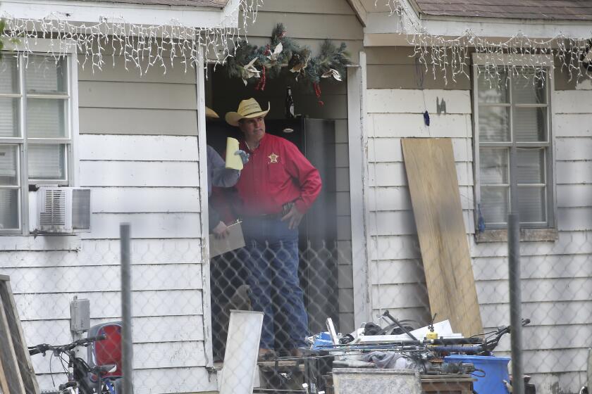 San Jacinto County Sheriff Greg Capers at a home near Cleveland, Texas, where five people were killed.