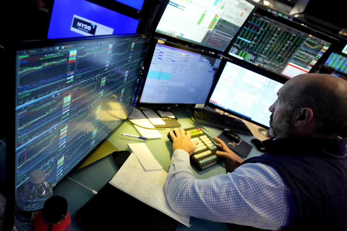 Specialist James Denaro works at his post on the floor of the New York Stock Exchange