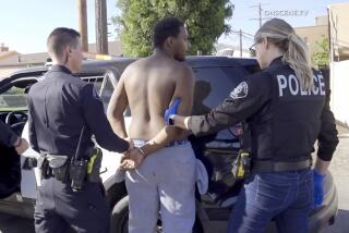 Newport Beach police officers take Leroy McCrary into custody in South Gate on July 2 after an attempted robbery.