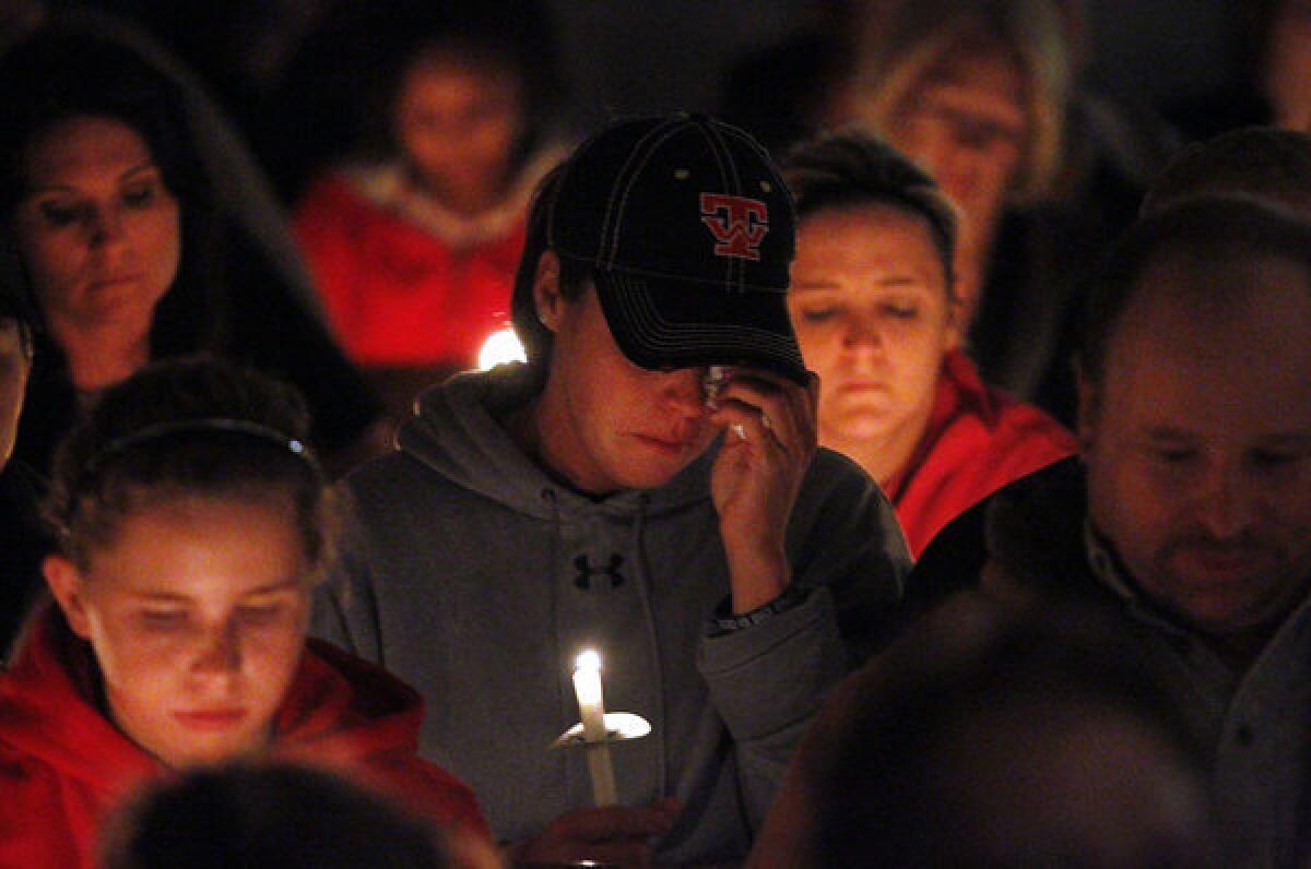 People mourn and pray during a candlelight vigil Thursday night at Assumption Catholic Church in West, Texas, for victims of the recent fertilizer plant explosion.