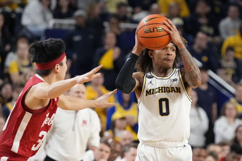 Michigan guard Dug McDaniel (0) looks to pass as Nebraska guard Keisei Tominaga (30) defends during the second half of an NCAA college basketball game, Wednesday, Feb. 8, 2023, in Ann Arbor, Mich. (AP Photo/Carlos Osorio)