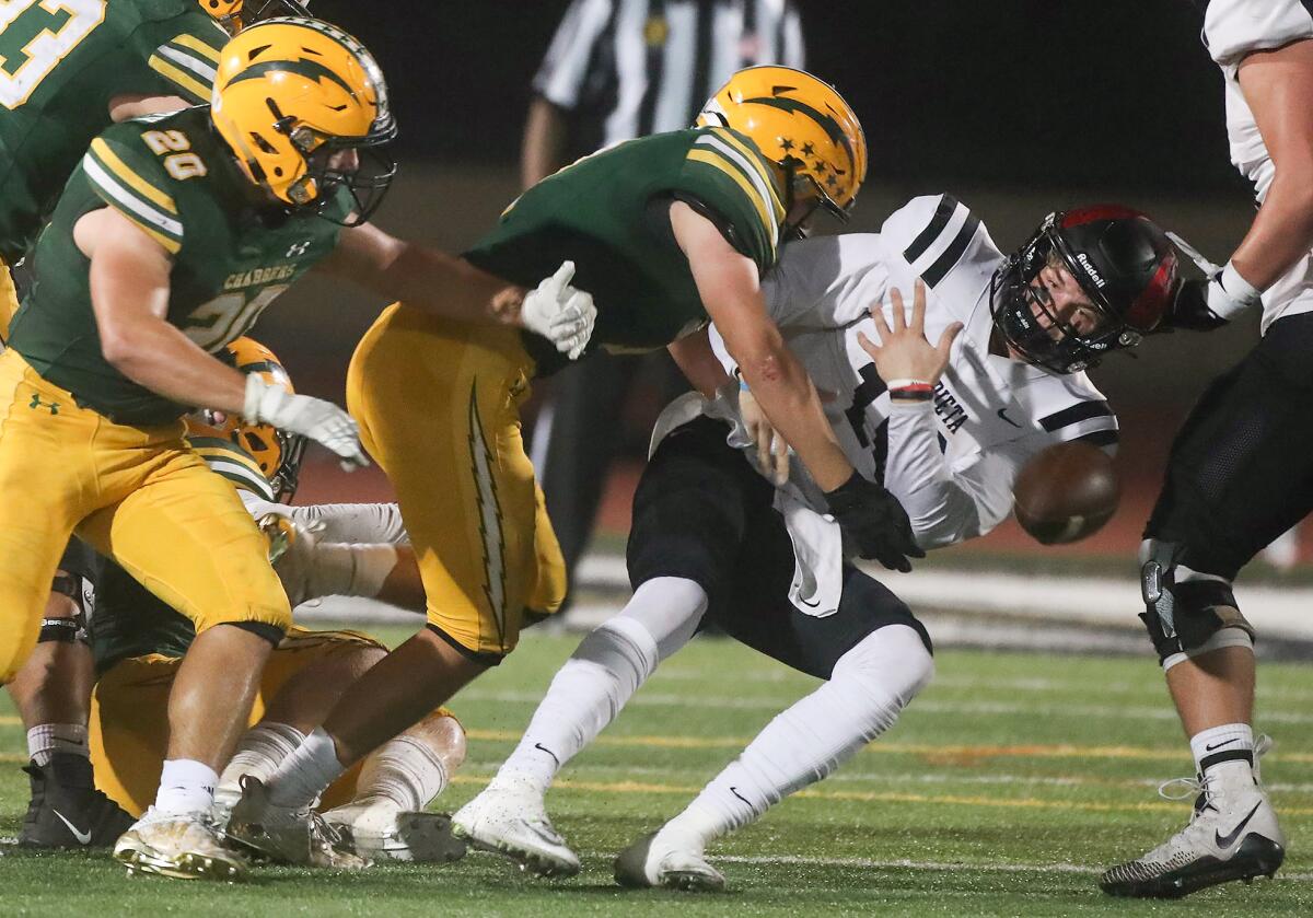 Edison defenders tackle Murrieta Valley quarterback Brandon Rose, who fumbles the ball in the process on Friday.