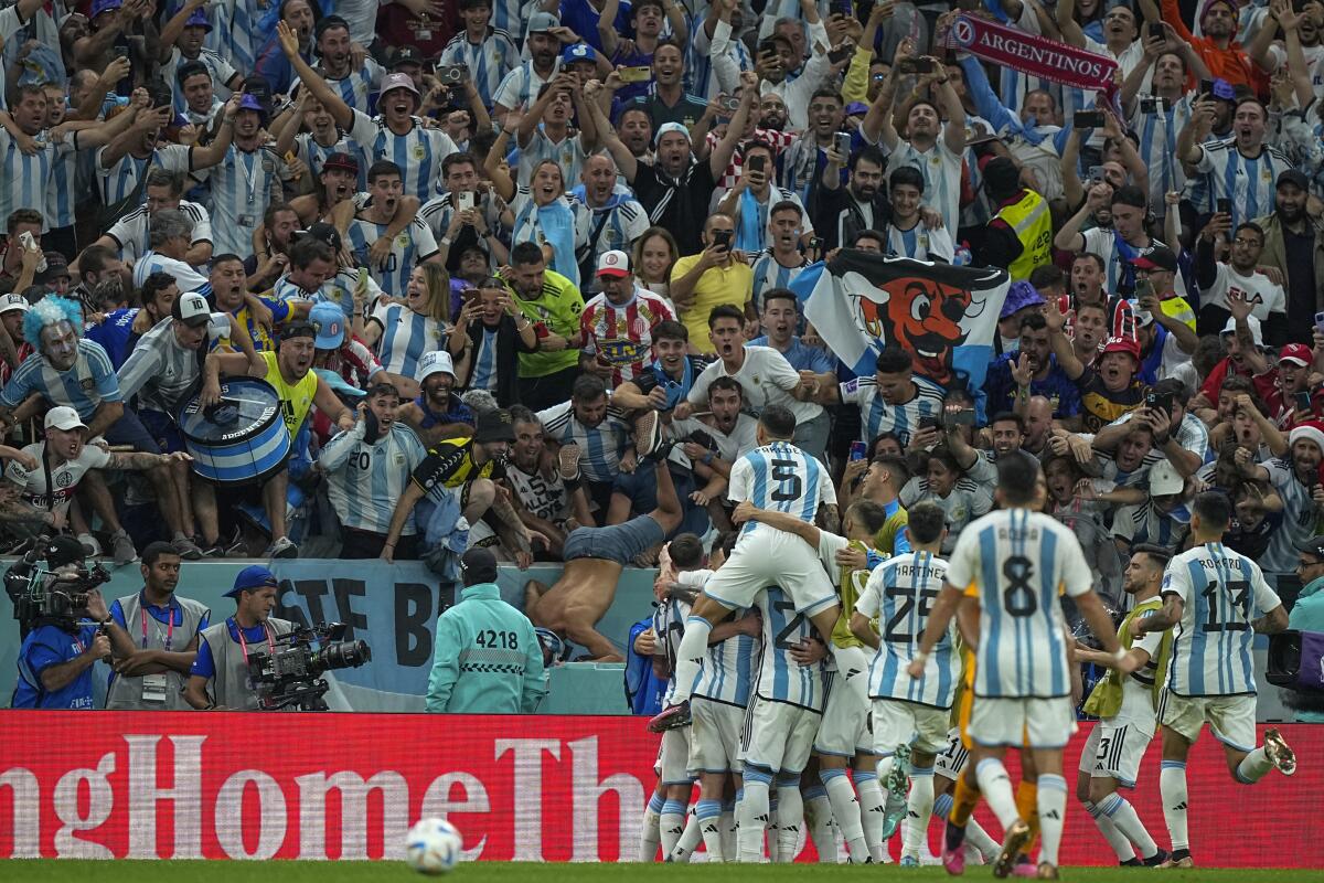 Fans cheers as Argentina's players celebrate a goal during a World Cup quarterfinal win.