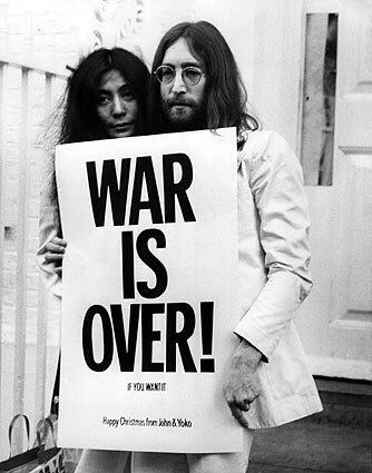 John Lennon and Yoko Ono pose on the steps of the Apple building in London in 1969, holding one of the posters they distributed to the world's major cities as part of a peace campaign protesting the Vietnam War. Related: In My Life: Robert Hilburn's 'Corn Flakes With John Lennon'