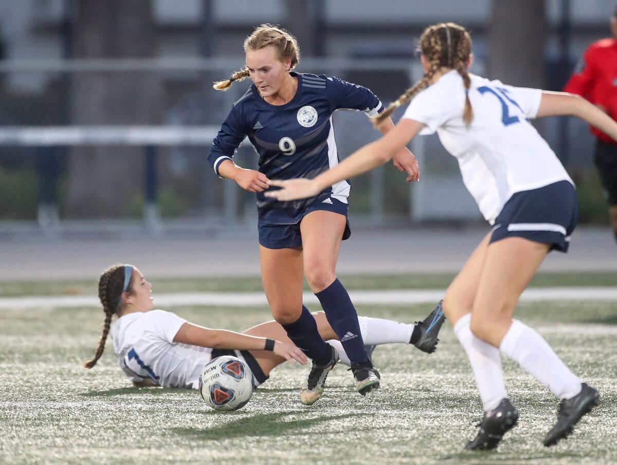 Newport Harbor's Brielle Benedict (9) makes a move through the Marina defense during a Wave League girls' soccer game.