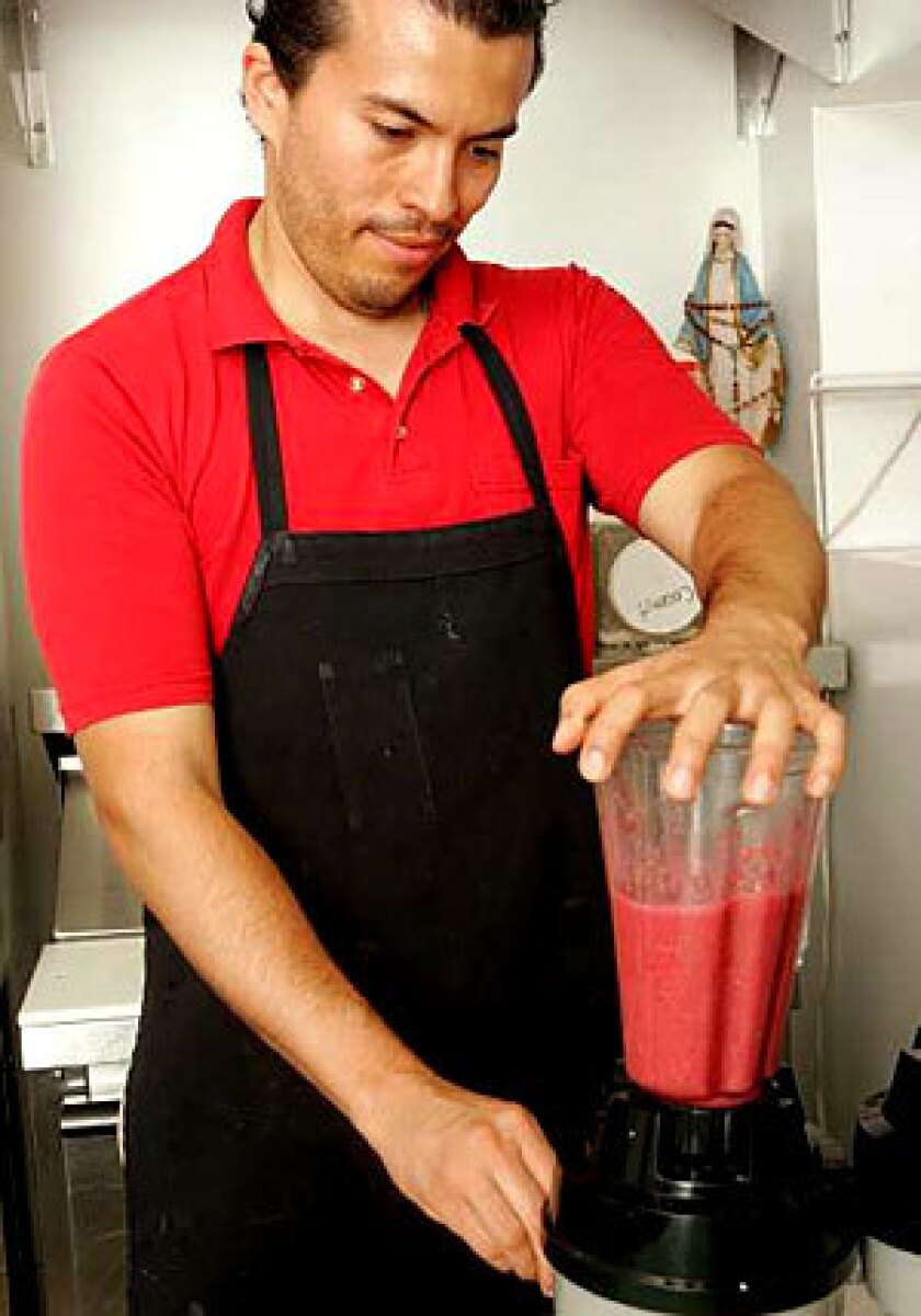 OLIMPUS JUICES: Jorge Mora puts blends smoothie in motion.