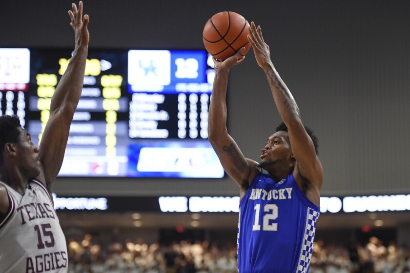 Kentucky forward Keion Brooks Jr. (12) shoots over Texas A&M forward Henry Coleman III (15) during the first half of an NCAA college basketball game Wednesday, Jan. 19, 2022, in College Station, Texas. (AP Photo/Justin Rex)