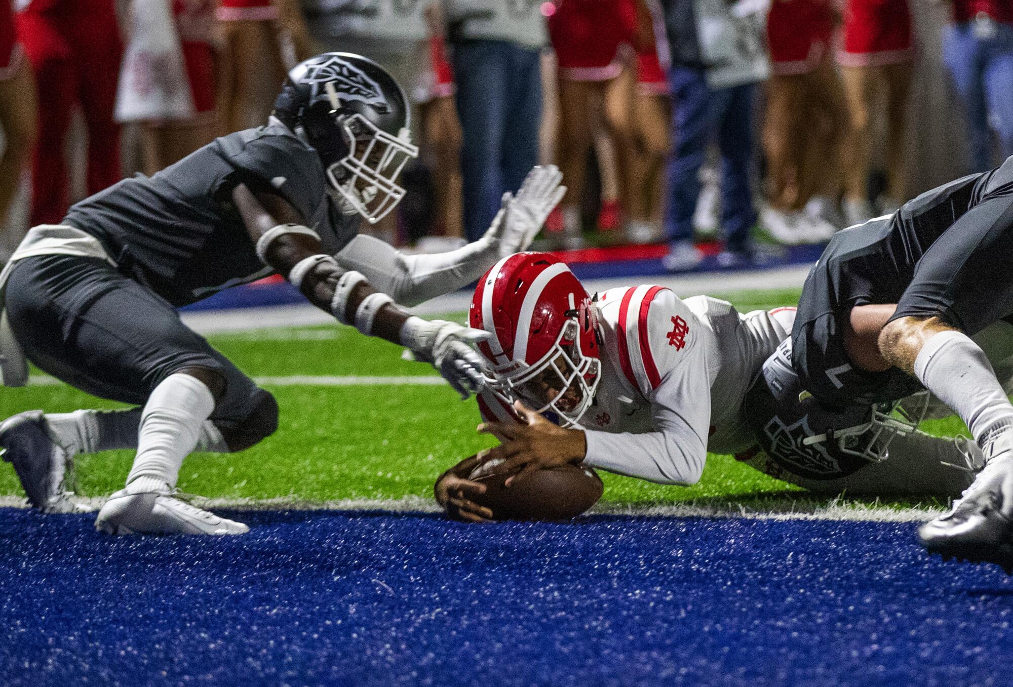 Bryce Young dives into the end zone to score a touchdown for Mater Dei against rival St. John Bosco.