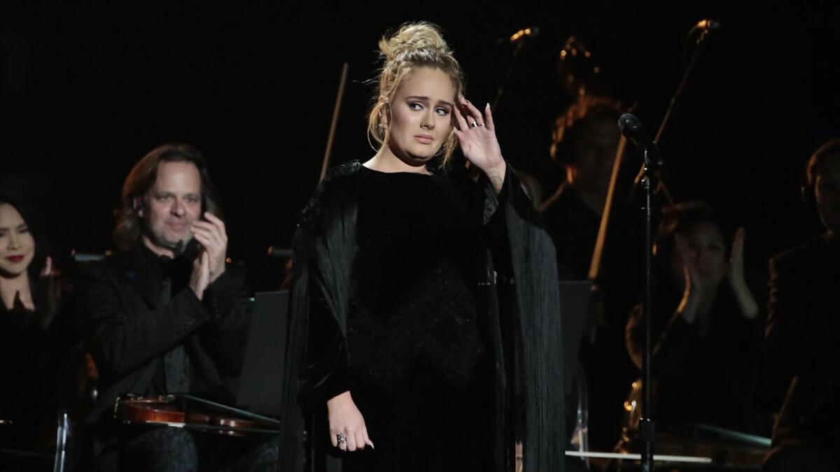 A distraught Adele is shown.