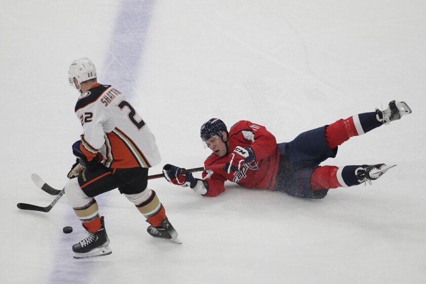 Anaheim Ducks' Kevin Shattenkirk (22) and Washington Capitals' Daniel Sprong (10) battle for the puck during the first period of an NHL hockey game, Monday, Dec. 6, 2021, in Washington. (AP Photo/Luis M. Alvarez)