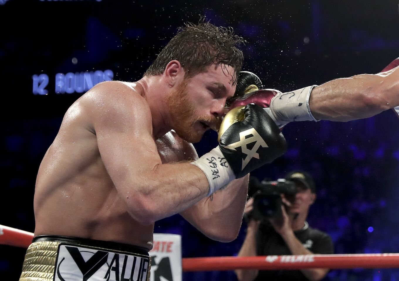 Canelo Alvarez takes a punch from Gennady Golovkin in the 10th round during a middleweight title boxing match, Saturday, Sept. 15, 2018, in Las Vegas.