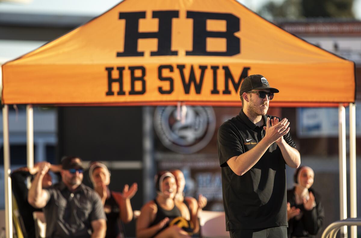 Huntington Beach's head coach Jacob Moore cheers on his team during a CIF Southern Section Division 1 playoff game.