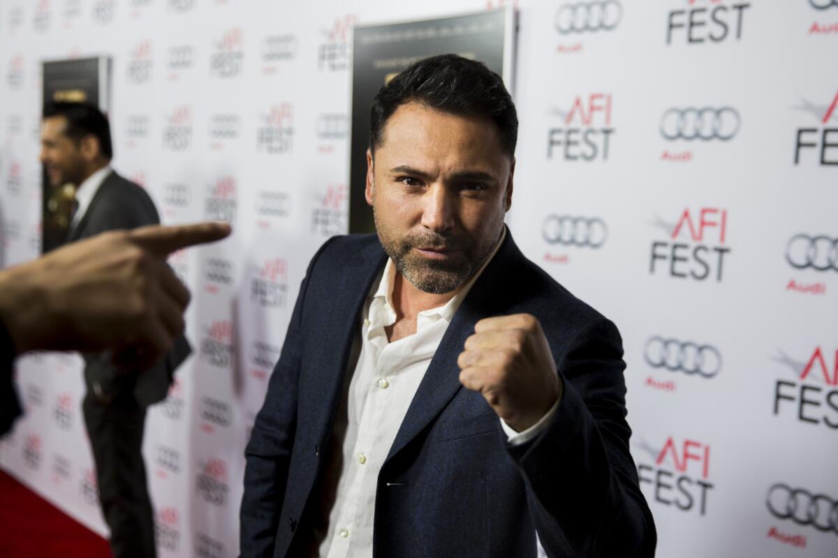 Oscar De La Hoya, poses for photos on the red carpet before the premiere of "33," at AFI FEST 2015 in Hollywood.