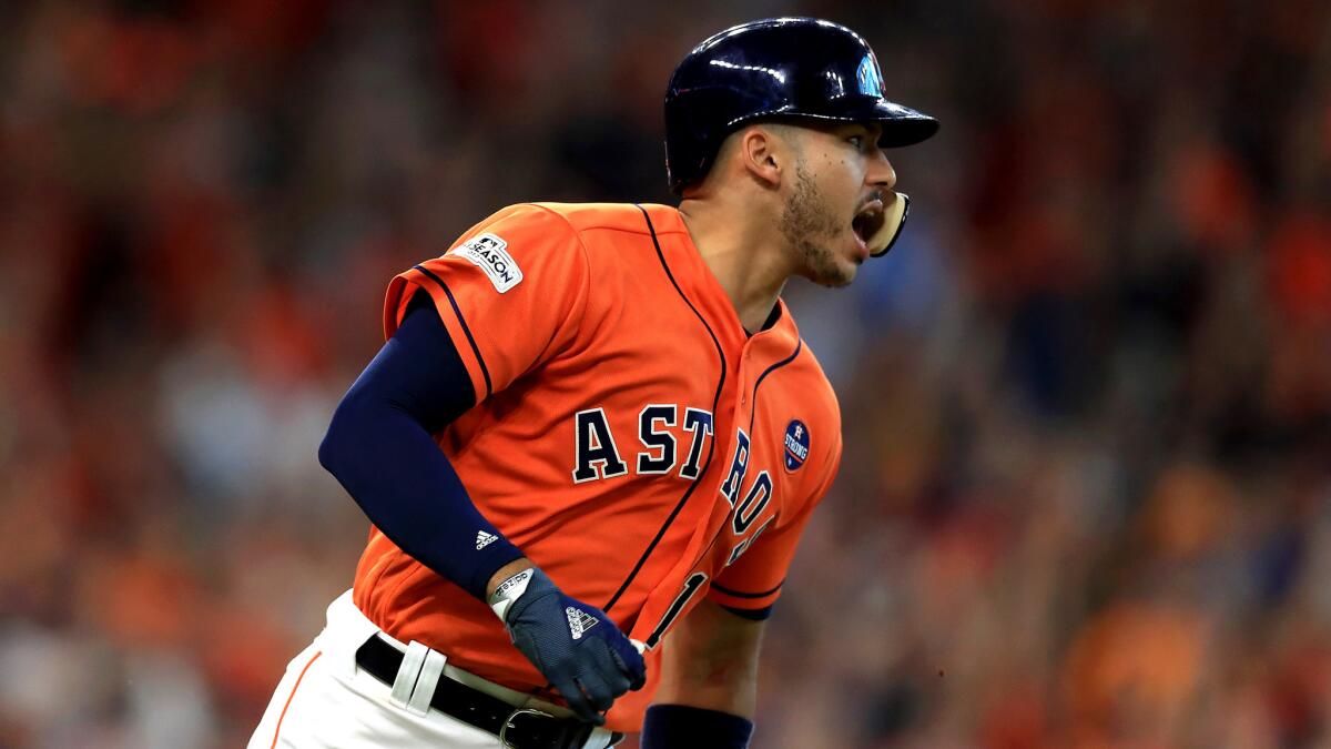 Astros shortstop Carlos Correa reacts after hitting a two-run double in the sixth inning against the Red Sox on Friday.