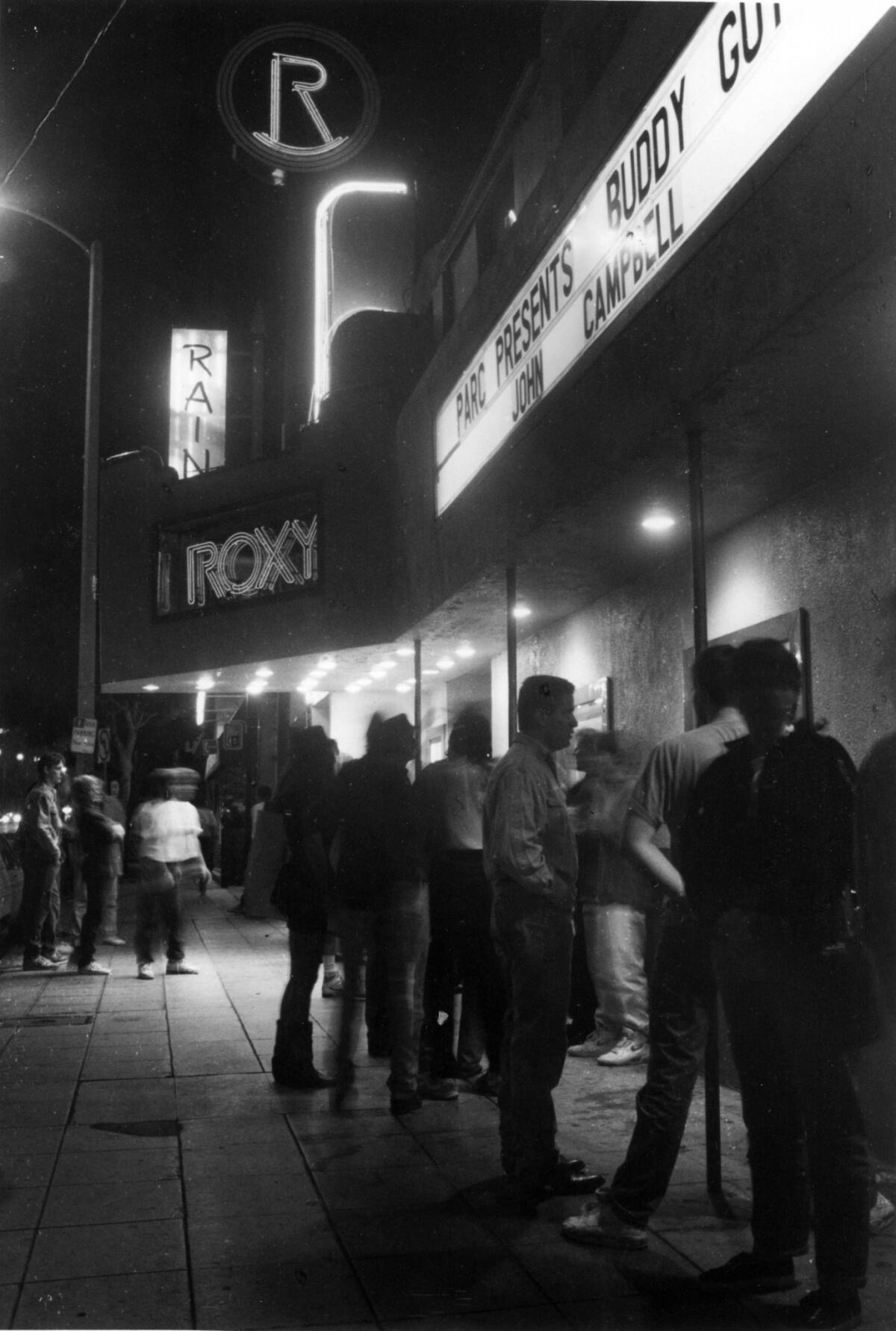 People gather outside the Roxy Theater in 1991. (Mike Meadows / Los Angeles Times)