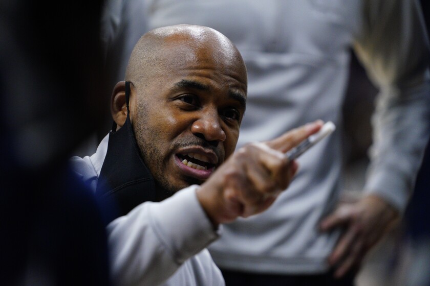 Saint Peter's Shaheen Holloway talks to his players during the first half of a college basketball game against Purdue in the Sweet 16 round of the NCAA tournament, Friday, March 25, 2022, in Philadelphia. (AP Photo/Chris Szagola)