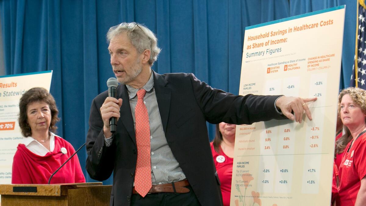 Professor Robert Pollin, a researcher from the University of Massachusetts Amherst, gestures to a chart showing estimates of cost savings under a proposed single-payer system in California on May 31 in Sacramento.