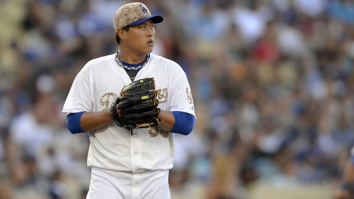Dodgers starter Hyun-Jin Ryu looks toward the scoreboard during the seventh inning of the Dodgers' 4-3 win over the Cincinnati Reds at Dodger Stadium on Monday.