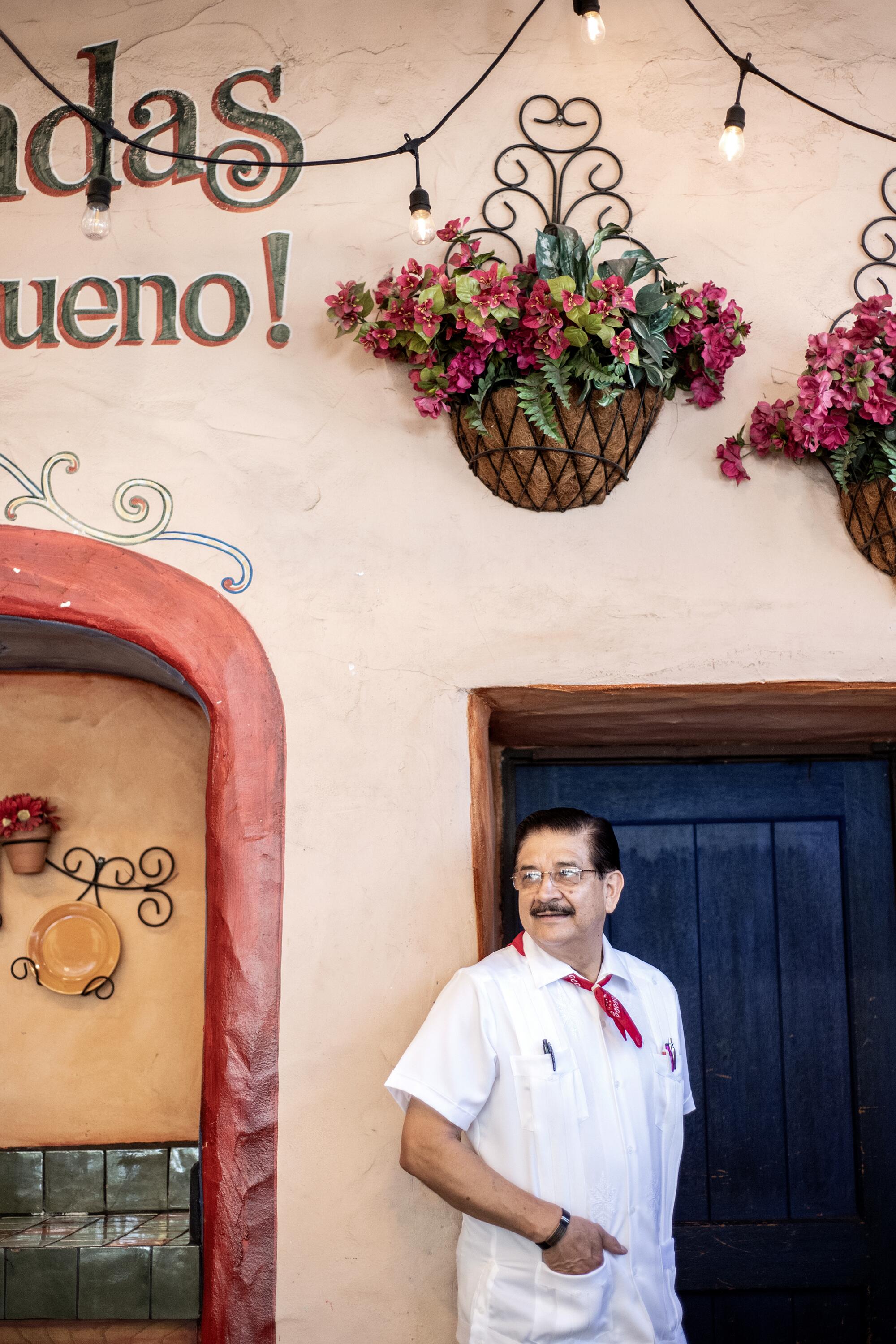 Justino Romero leaning against a wall in El Cholo restaurant.