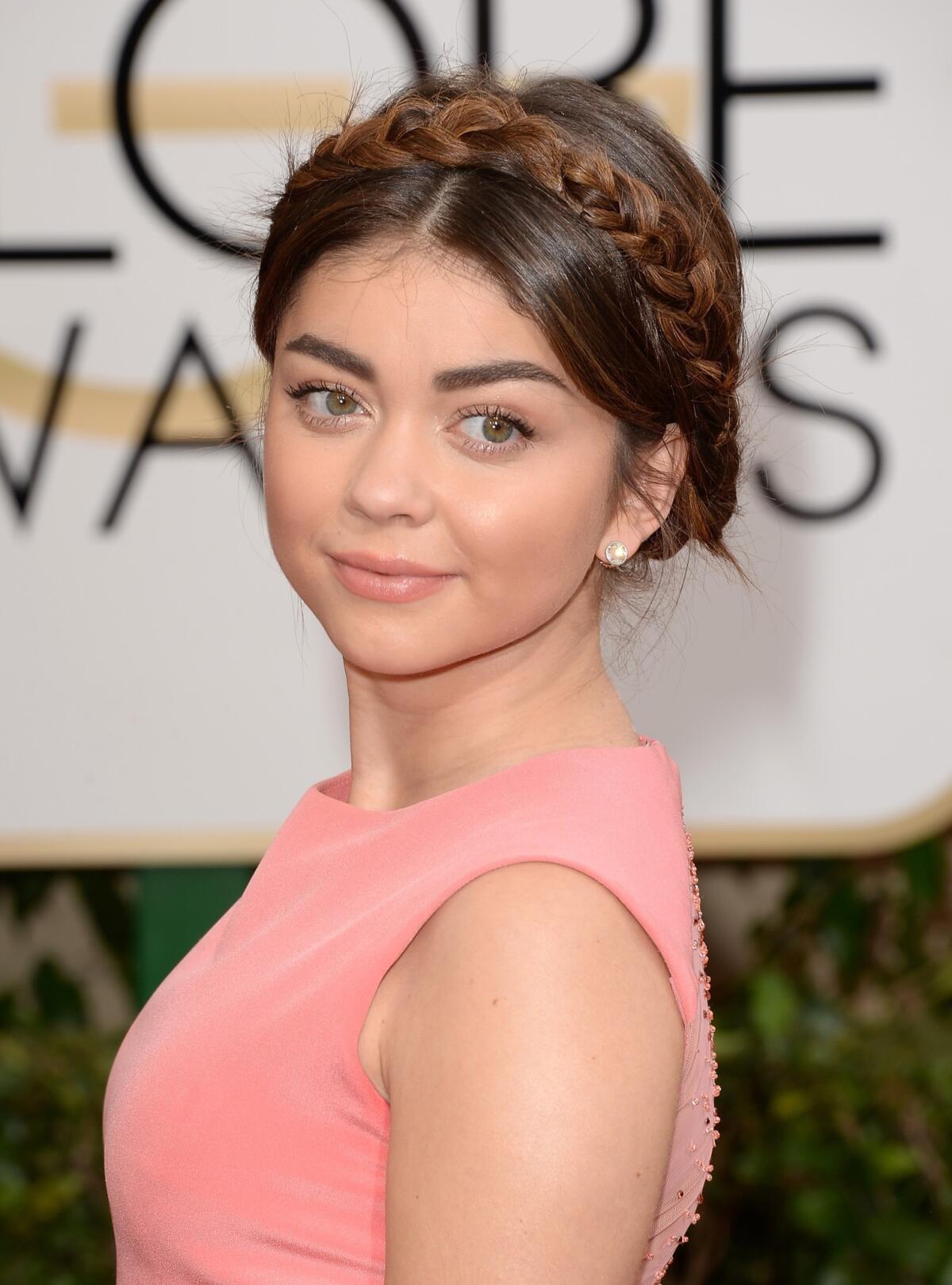 "Modern Family" actress Sarah Hyland wears her hair in a crown braid to Sunday's Golden Globes.