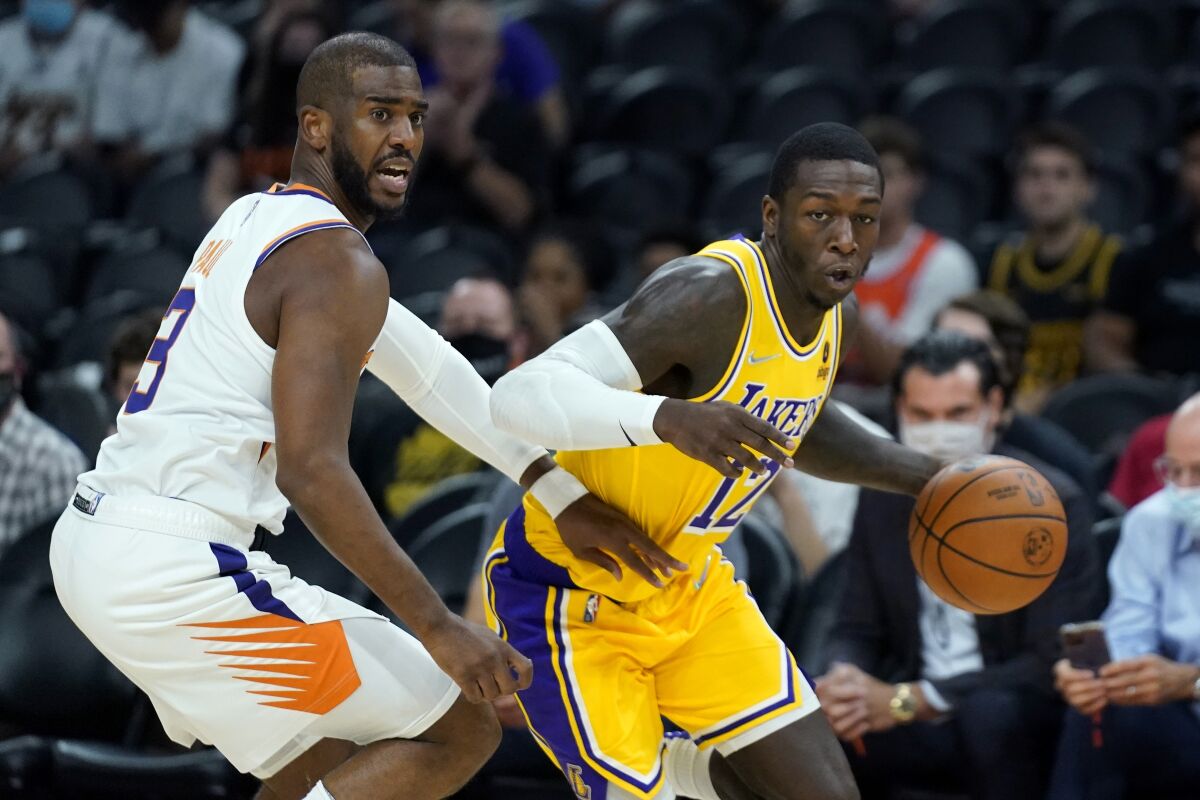 Kendrick Nunn tries to get past a guard during a Lakers game.