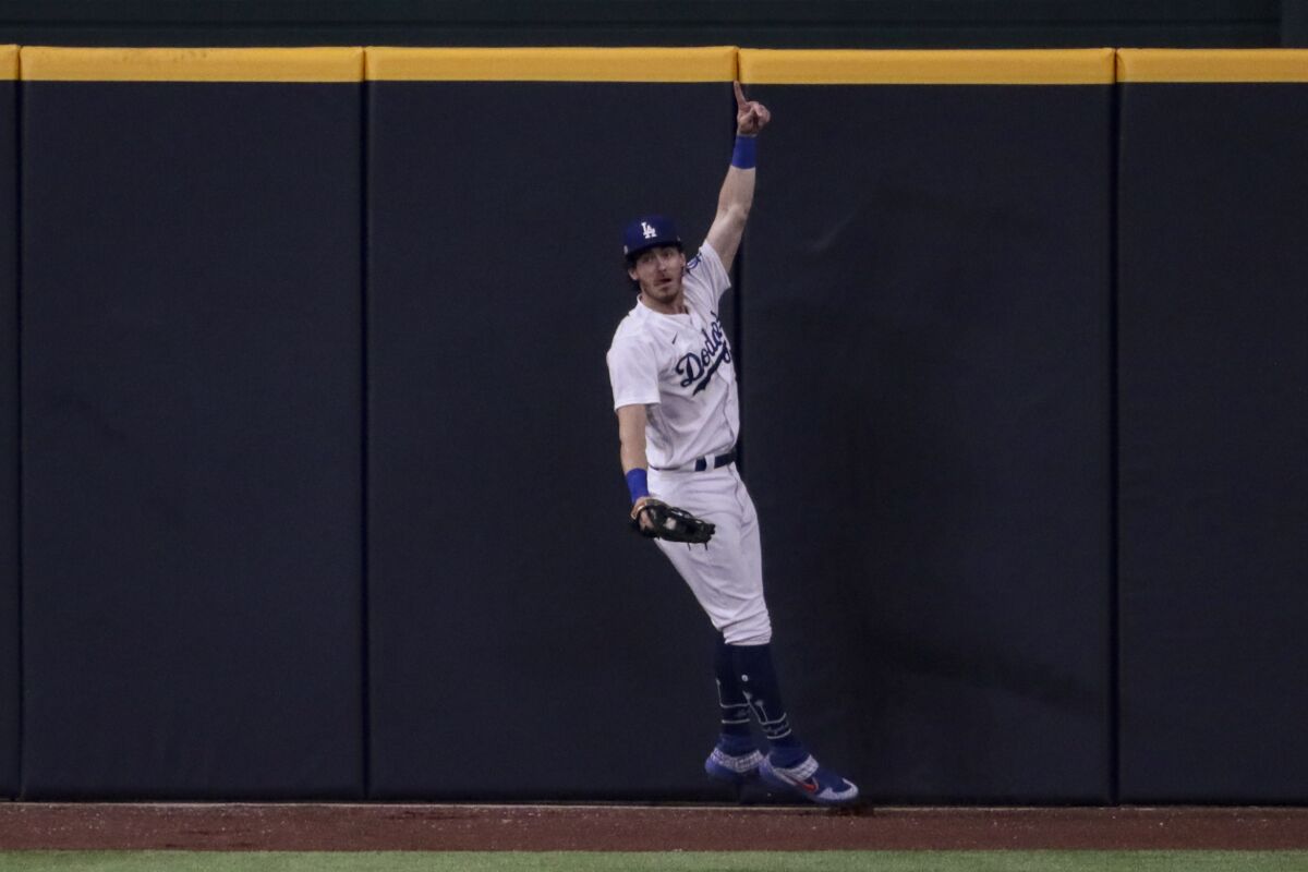 Dodgers center Cody Bellinger celebrates after making a catch to prevent a home run by San Diego's Fernando Tatis Jr.