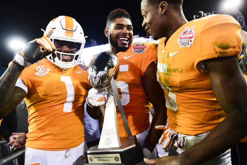 Tennessee wide receiver Jauan Jennings (15) holds the trophy next to wide receivers Marquez Callaway (1) and Josh Palmer (5) after the team's 23-22 win over Indiana in the Gator Bowl NCAA college football game in Jacksonville, Fla., Thursday, Jan. 2, 2020. (Calvin Mattheis/Knoxville News Sentinel via AP)