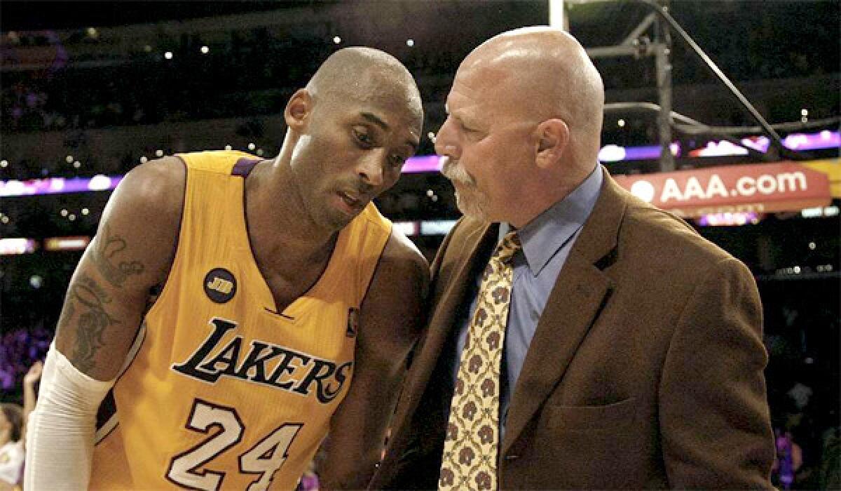 Kobe Bryant talks with Lakers trainer Gary Vitti after a game in March 2013. Vitti, who has been with the Lakers for more than 30 years, says the team's worst season ever can be traced back to the vetoed Chris Paul trade.