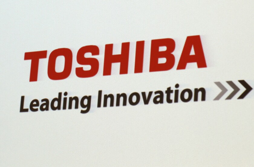 FILE - In this June 15, 2017, file photo, the logo of Toshiba Corp., Japan's electronics and energy company, is seen on a screen during a press conference in Yokosuka, near Tokyo. Embattled Japanese technology giant Toshiba on Monday, Feb. 7, 2022, announced it is splitting into two companies, one focused on infrastructure and the other on devices, to try to bring value to shareholders. (AP Photo/Shuji Kajiyama, File)