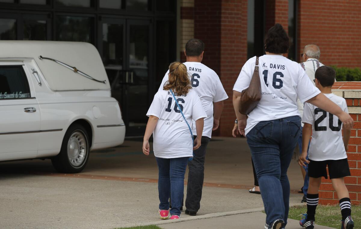 Mourners arrive for the funeral of Kyle Davis in Oklahoma City. Kyle, 8, was among six students who died in the tornado that hit the Plaza Towers Elementary School in Moore, Okla. Many mourners wore T-shirts with his name and number from his soccer team.