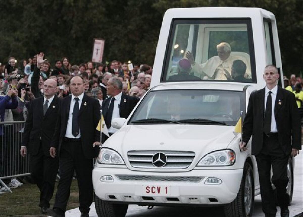 FILE - In this , Saturday, Sept. 18, 2010 file photo, Pope Benedict XVI, followed by security guards, arrives aboard of the popemobile in Hyde park to attend a Vigil prayer in London. An animal rights group has urged Pope Benedict XVI to "truly go green'' and insist that the next popemobile is made without leather. PETA said it has written to the Pope with the request following the Vatican's confirmation Wednesday, June 22, 2011, that Germany's Mercedes-Benz auto company is making a study of a hybrid, energy-saving popemobile. The car would replace the current Mercedes vehicle used when the Pope travels abroad. (AP Photo/Gregorio Borgia, File)