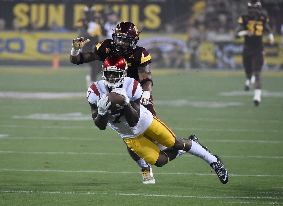 USC's Steven Mitchell Jr. attempts a diving catch in front of Arizona State's Lloyd Carrington during the first half Saturday in Tempe, Ariz.