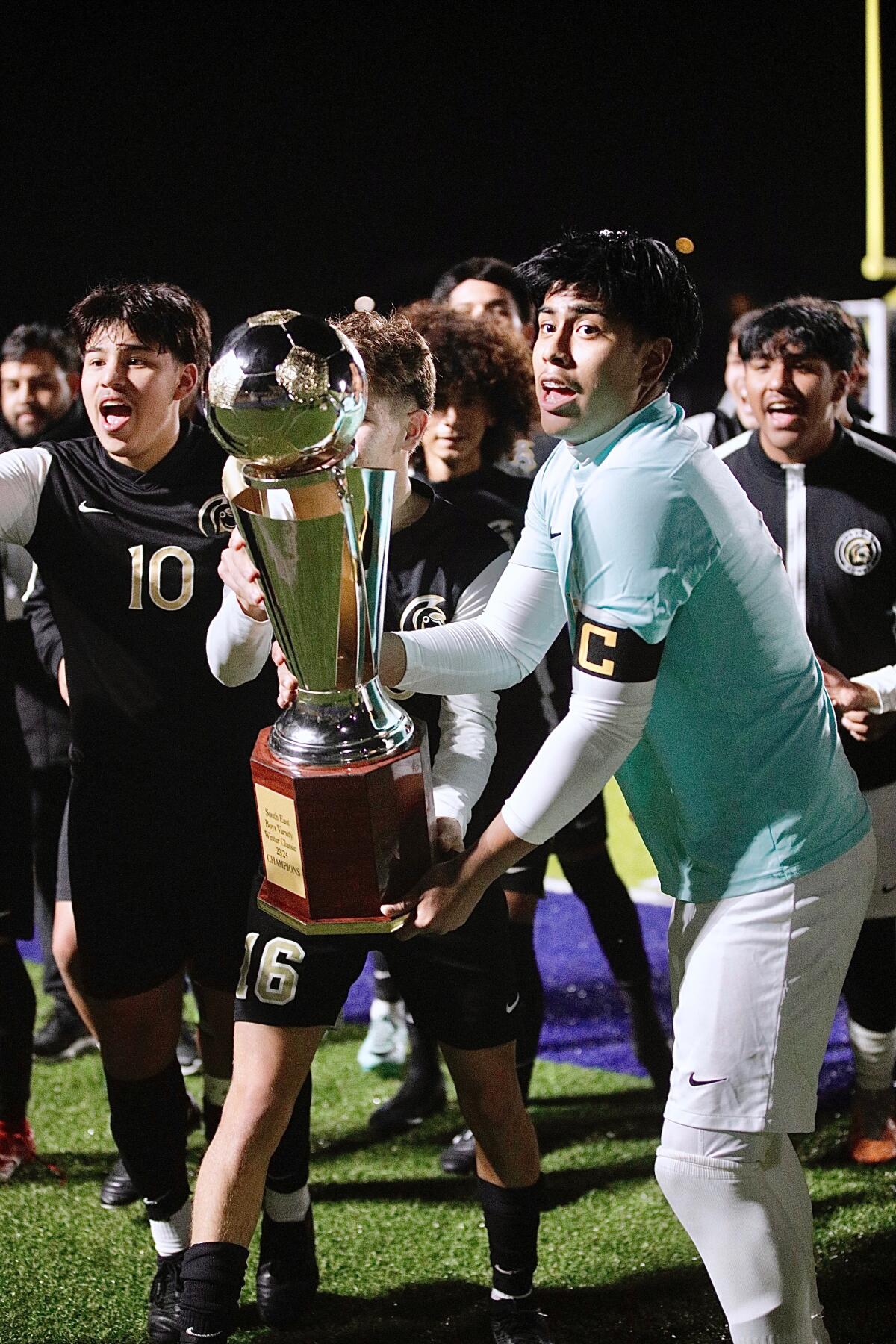 Irvin Yanez holds the championship trophy.