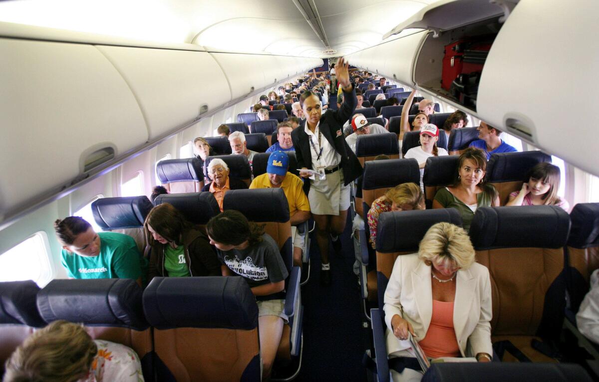Passengers sit in their assigned seats before take-off July 10, 2006 at San Diego's Lindburgh Field Airport in San Diego, Calif.
