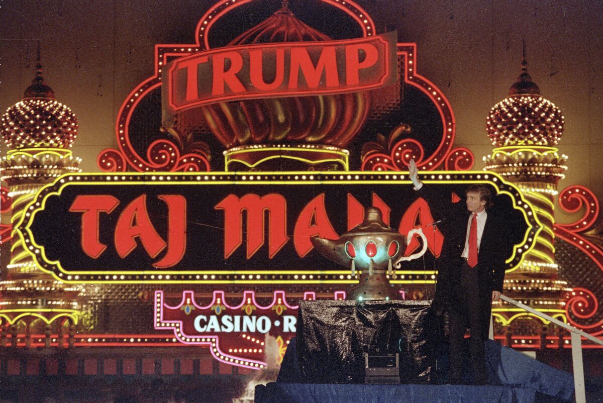 Donald Trump celebrates the grand opening of the Taj Mahal in 1990. The Atlantic City casino was in financial trouble later that year.