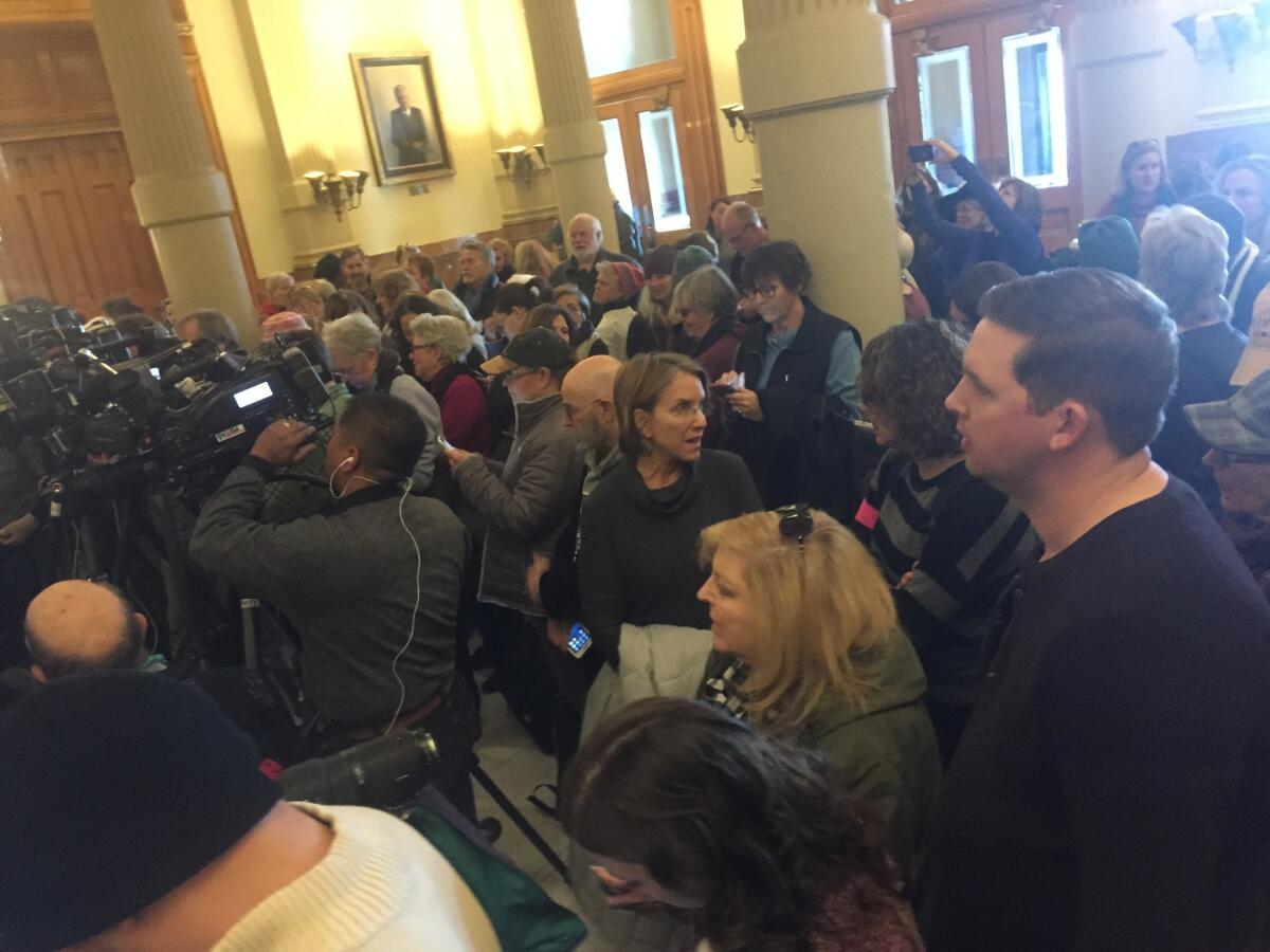 Crowds await the electoral college vote at the Colorado Capitol in Denver.