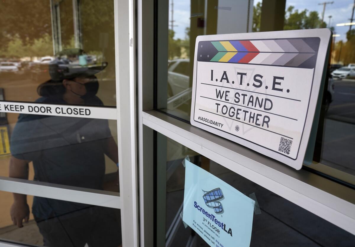 A man enters the union offices of The International Alliance of Theatrical Stage Employees (IATSE) Local 80, Monday, Oct. 4, 2021, in Burbank, Calif. The IATSE overwhelmingly voted to authorize a strike for the first time in its 128-year history. (AP Photo/Chris Pizzello)