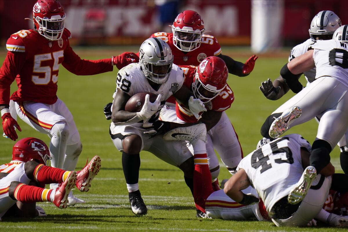 Las Vegas Raiders running back Josh Jacobs is tackled by Kansas City Chiefs inside linebacker Anthony Hitchens.